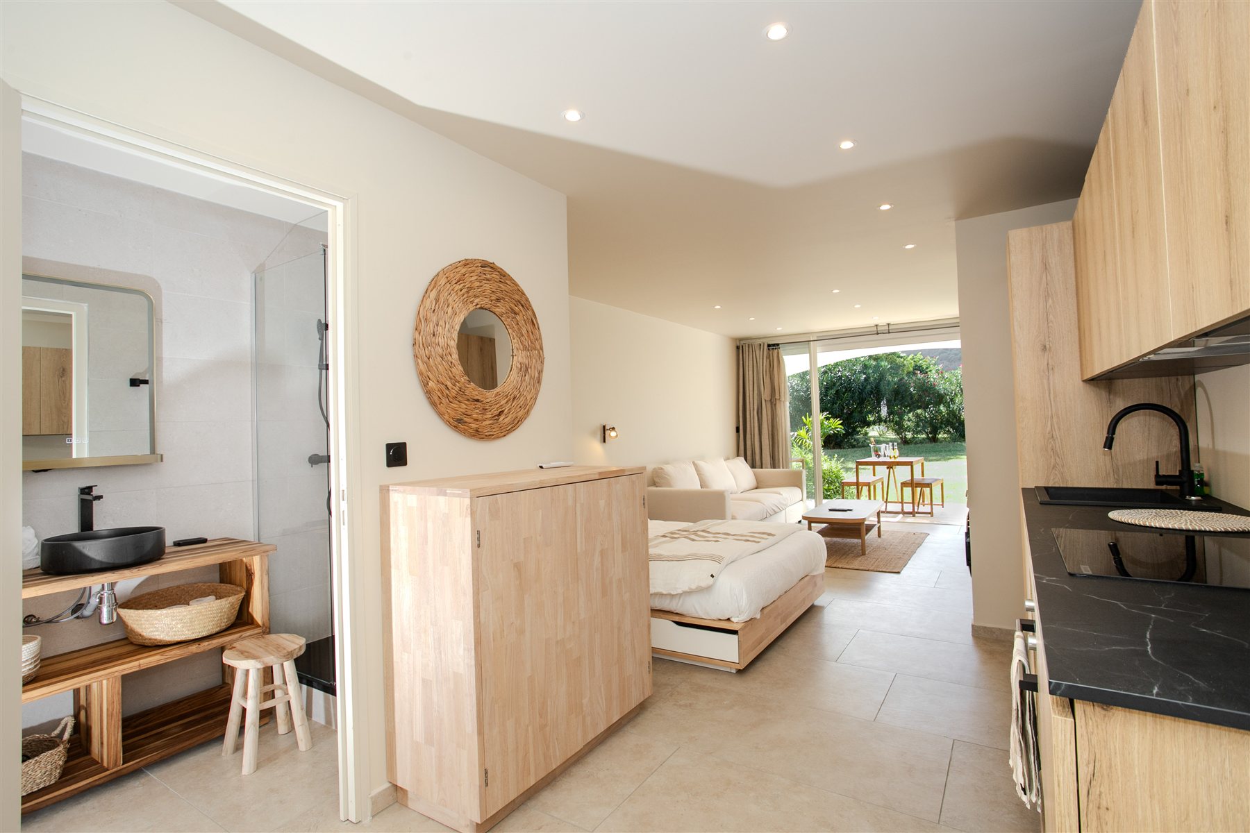 Apartment interior with a sleeping area, kitchen and garden access